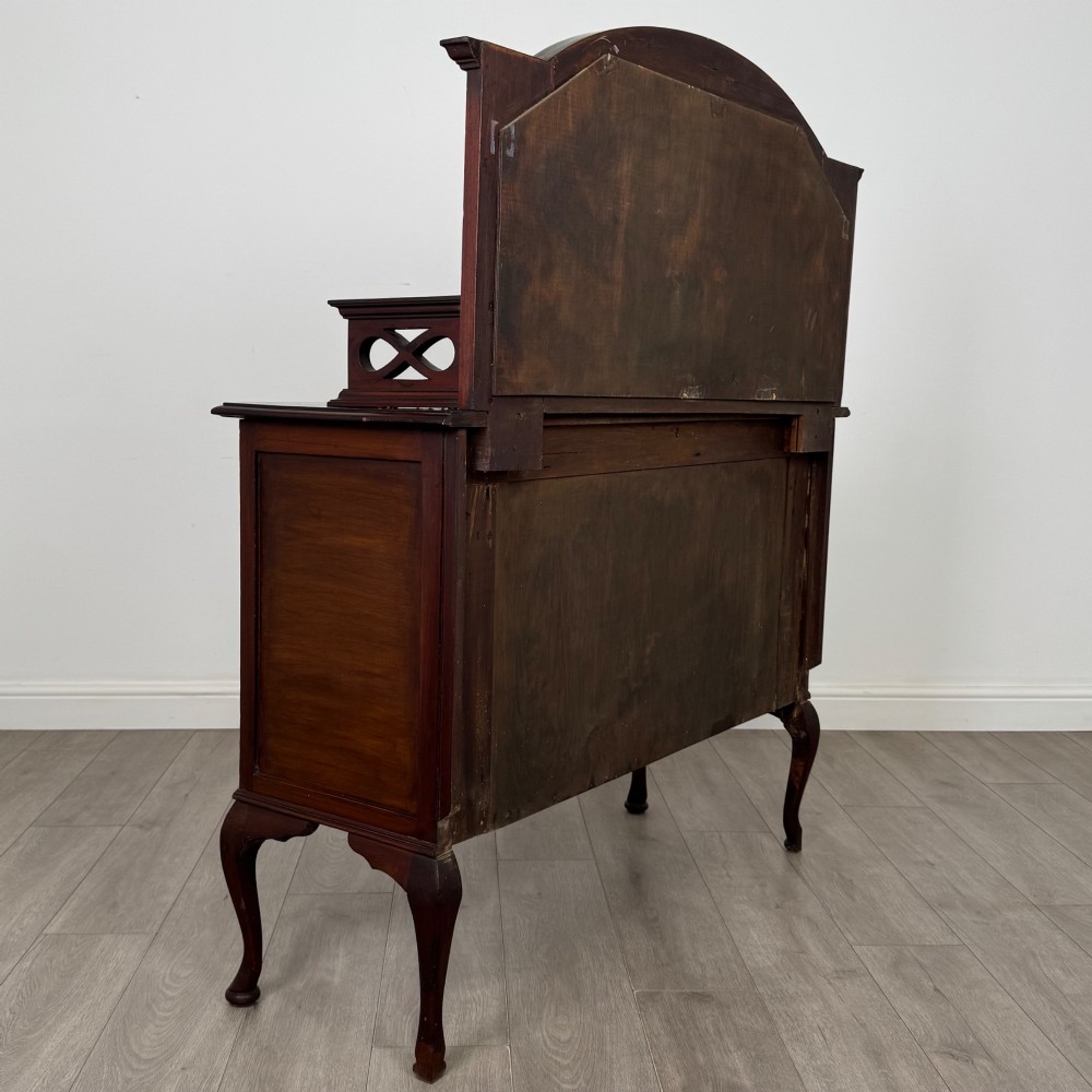 An antique Edwardian mahogany sideboard featuring a top section with a central oval mirror, two drawers, and a two-door cabinet below raised on cabriole legs. View V