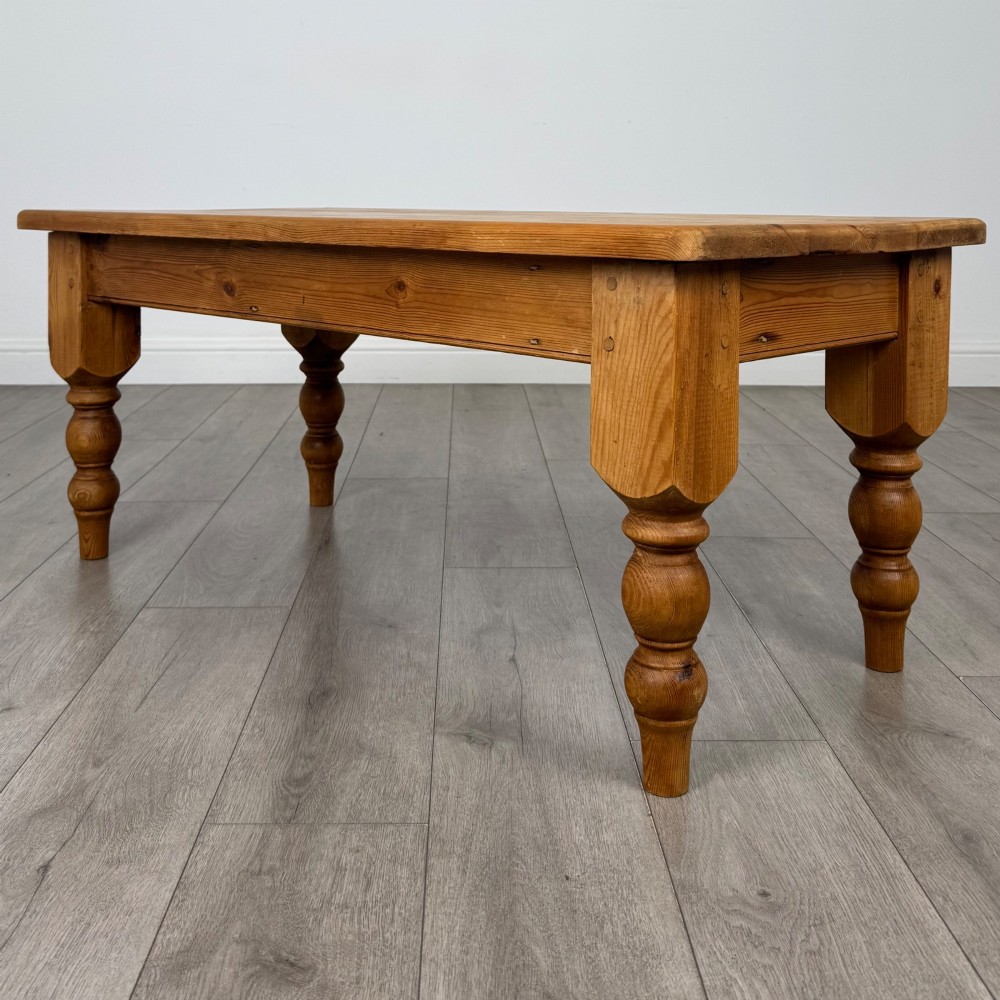 A low rectangular pine coffee table featuring turned baluster legs and visible wooden grain across its solid tabletop. View II