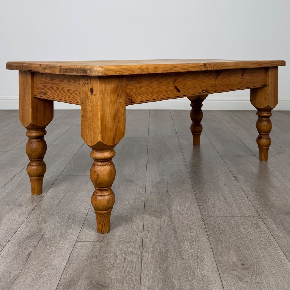 A low rectangular pine coffee table featuring turned baluster legs and visible wooden grain across its solid tabletop. View IV