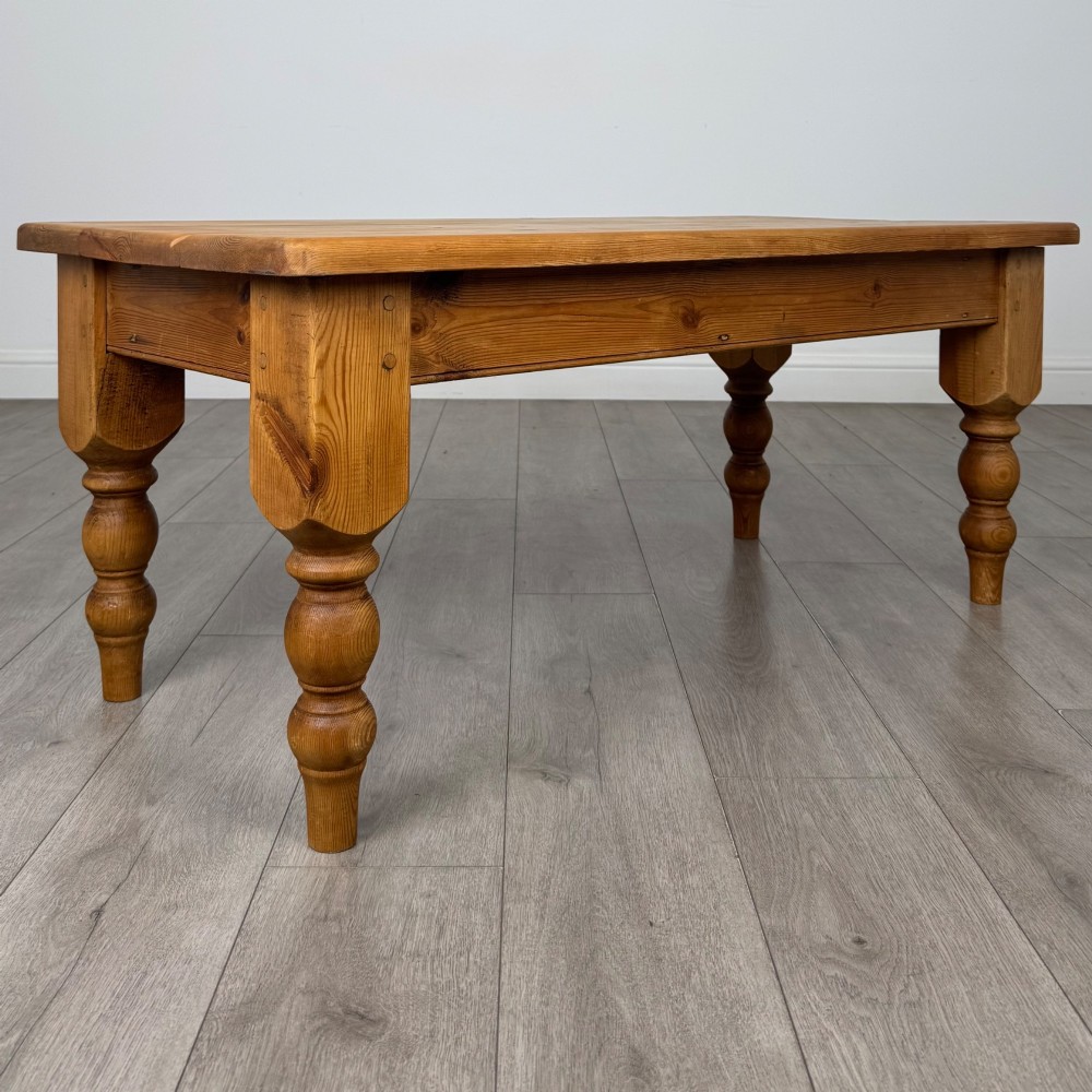 A low rectangular pine coffee table featuring turned baluster legs and visible wooden grain across its solid tabletop. View VIII
