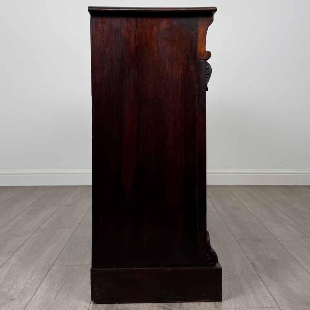 A low 19th-century Victorian rosewood open bookcase with two wide shelves, carved acanthus leaf capitals, and a solid plinth base. View VII