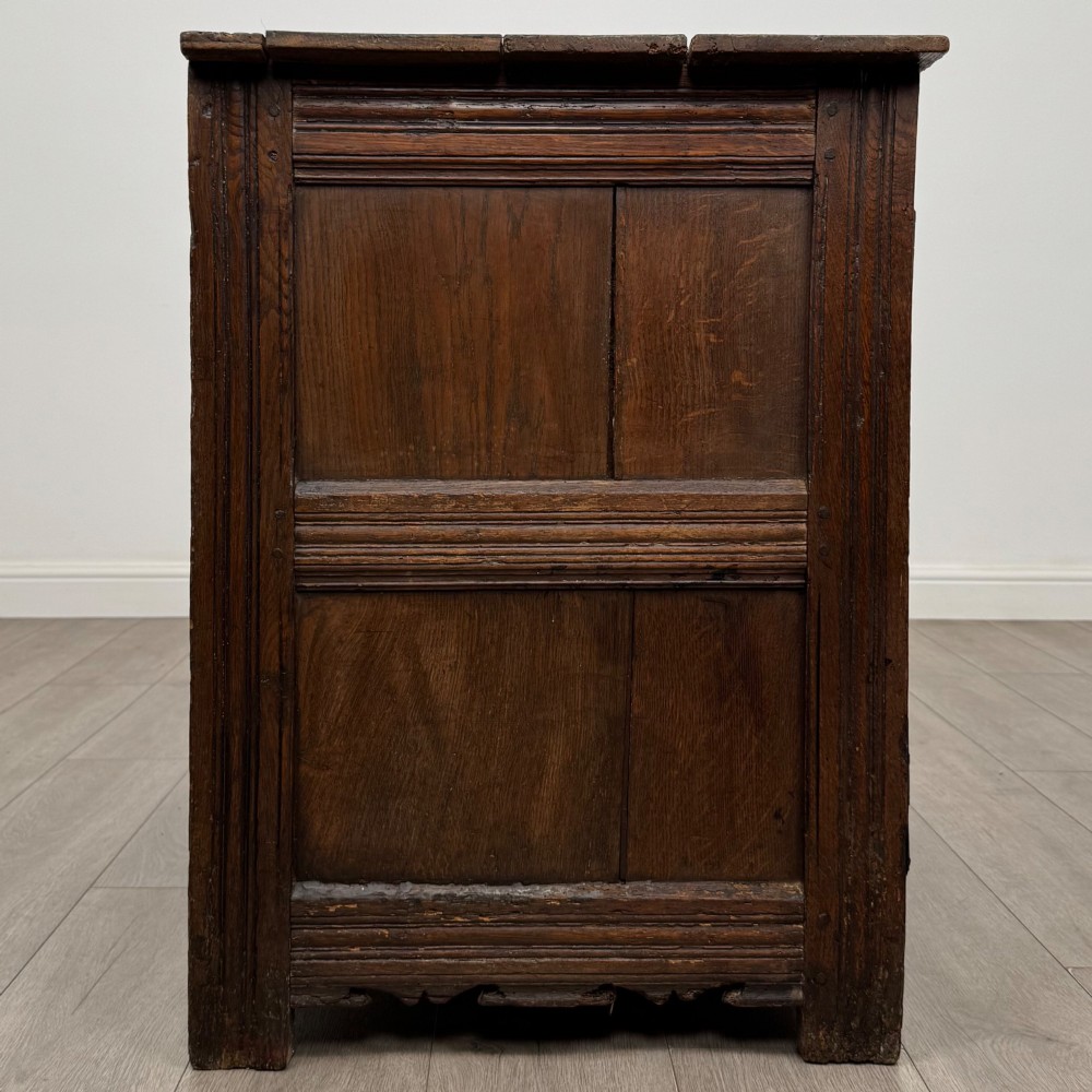 A seventeenth-century oak cupboard featuring two panelled doors with moulded trim and hand-forged iron hinges. View VIII