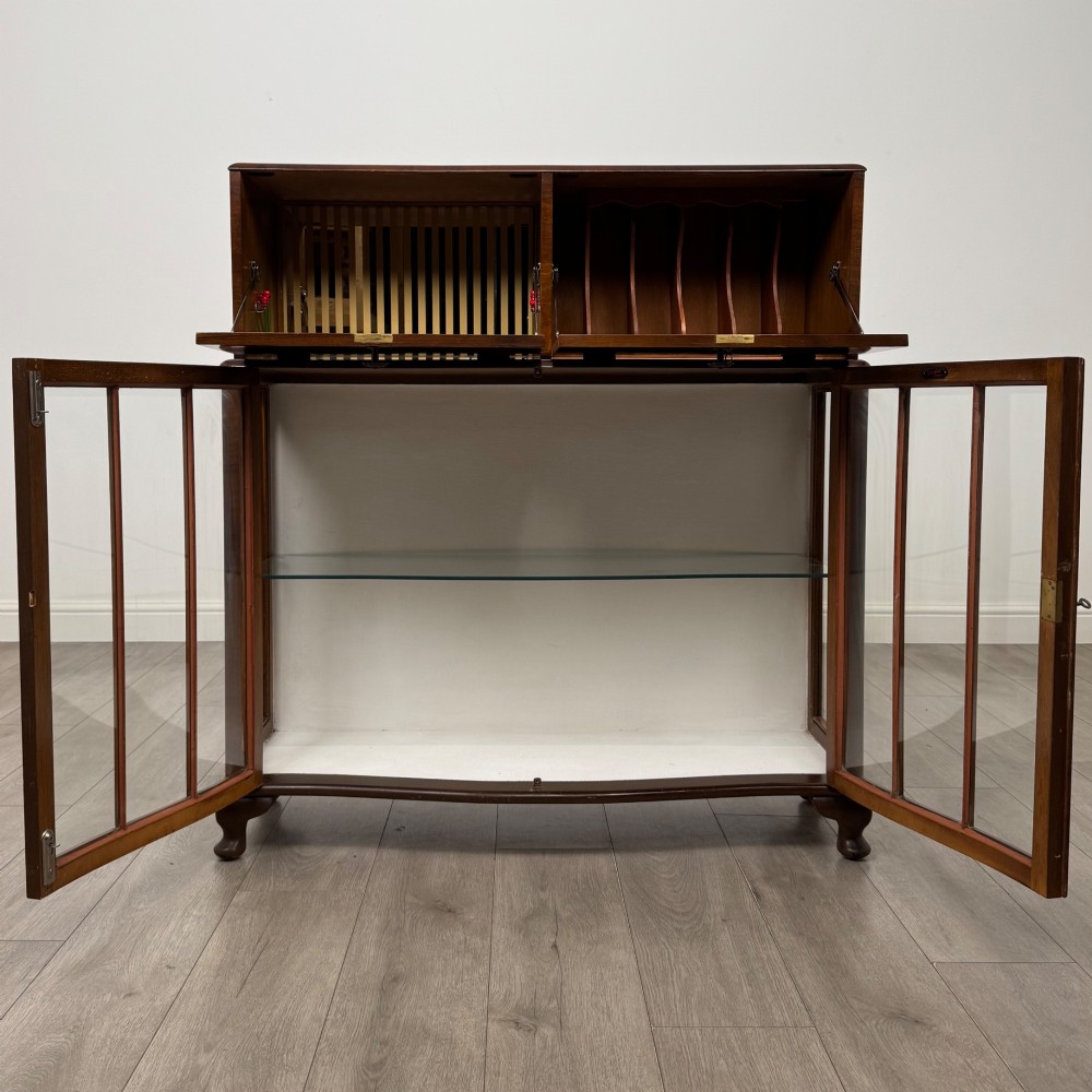 A 20th-century figured walnut fitted cabinet featuring upper solid doors above lower glazed doors with glass shelving. View III