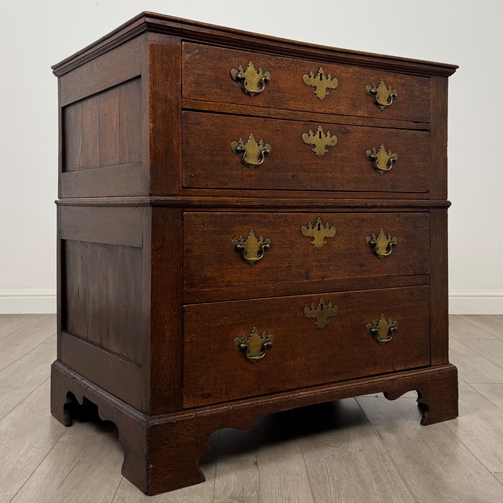A seventeenth-century William and Mary oak chest of drawers featuring four drawers with brass escutcheons and drop handles raised on bracket feet. View VIII