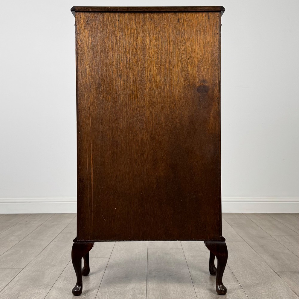 An antique mahogany display cabinet featuring a single door with geometric astragal glazing bars, glass shelves, and cabriole legs. View V