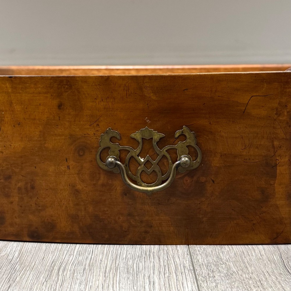 A 20th-century burr walnut sideboard featuring three central bowfront drawers flanked by cupboard doors, supported on carved cabriole legs. View XII