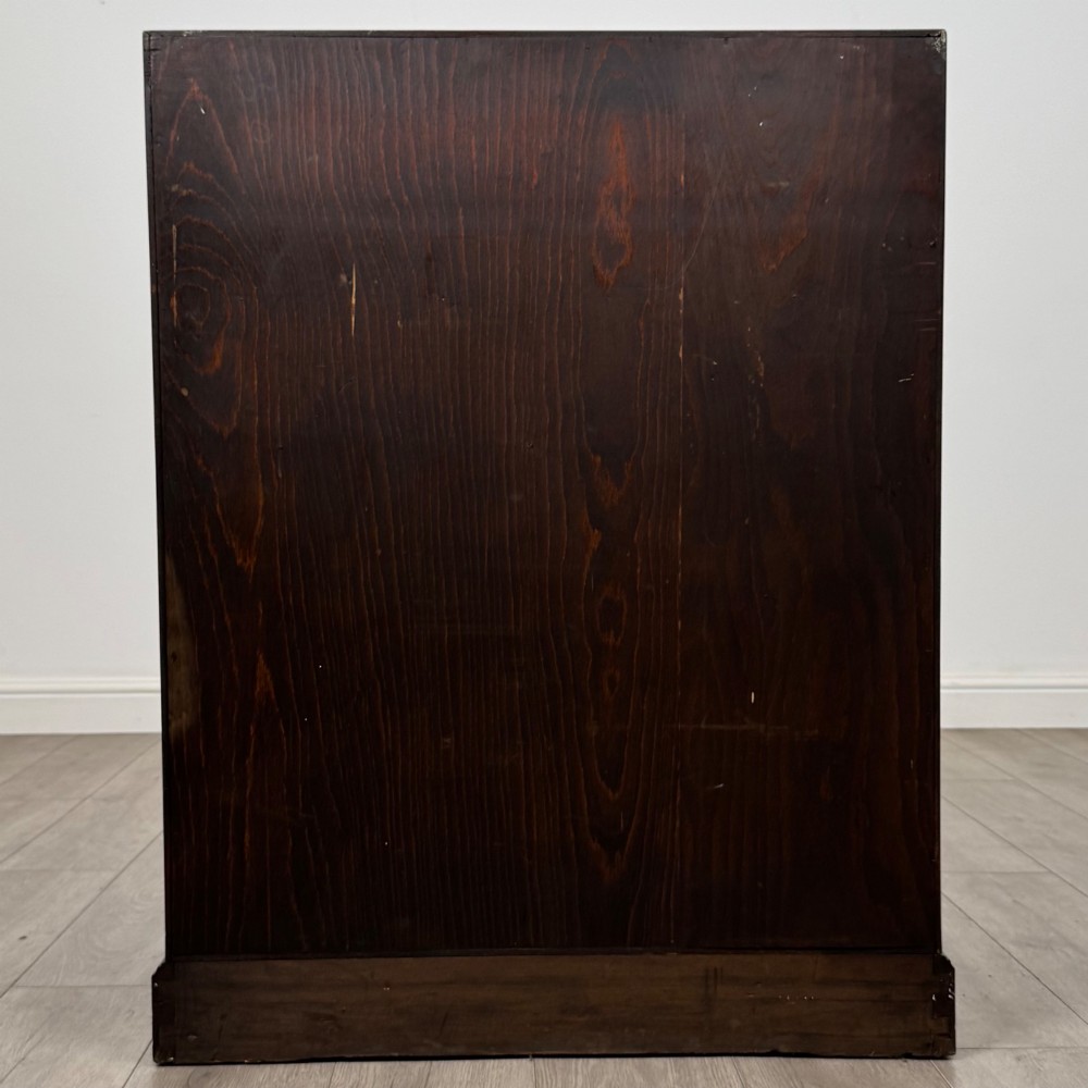 A dark oak Jacobean style slant-front bureau featuring geometric inlaid panels and four drawer fronts with turned wooden knobs. View VI