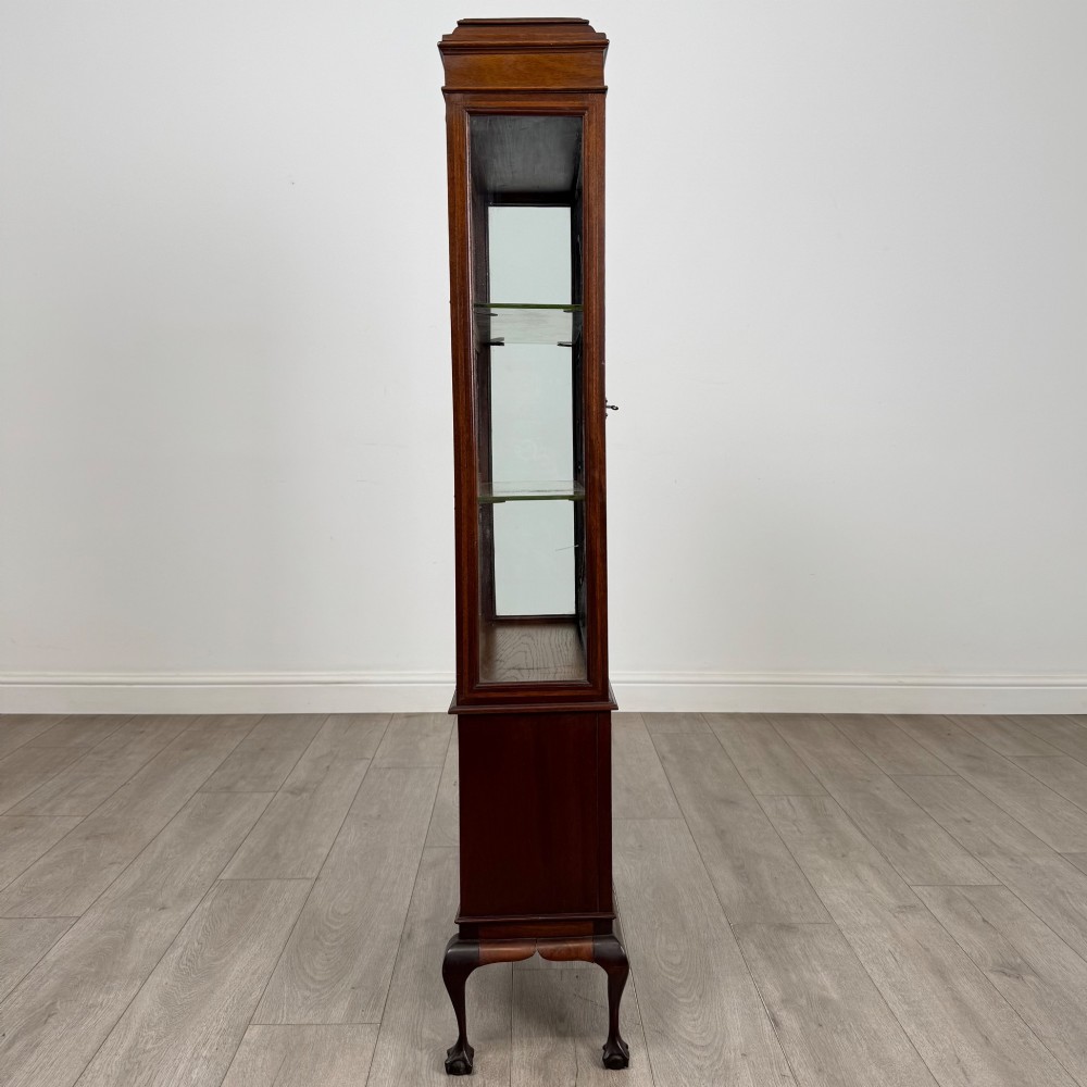 An early 20th-century mahogany glazed display cabinet featuring geometric astragal doors, marquetry inlaid lower cupboards, and cabriole legs. View VIII