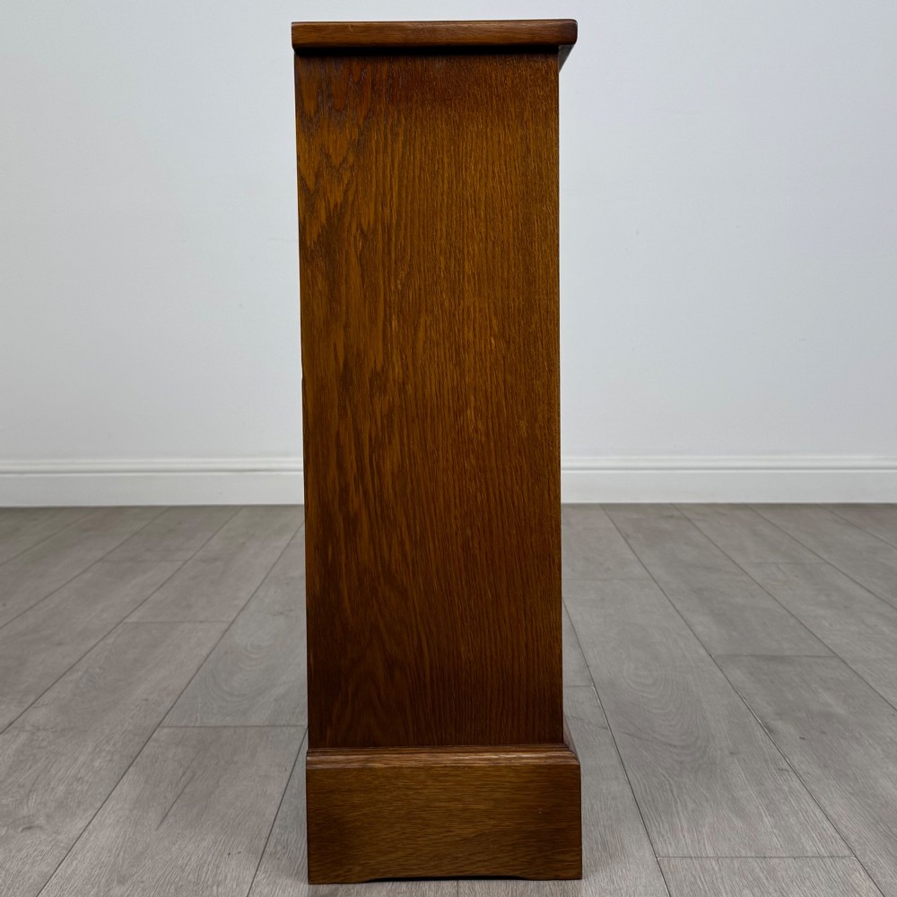 A small 20th-century open oak bookcase featuring two drawers at the top with dark twisted ring handles above two open shelves. View VII