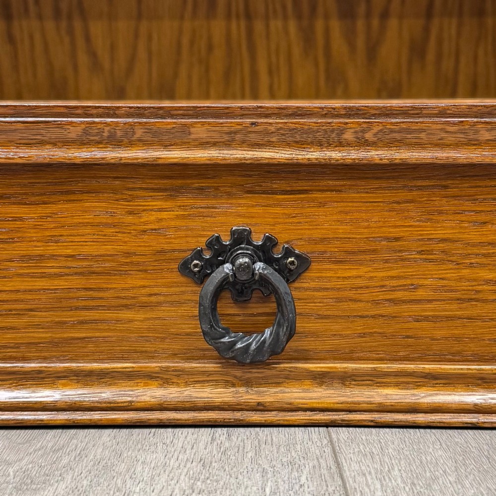 A small 20th-century open oak bookcase featuring two drawers at the top with dark twisted ring handles above two open shelves. View XI