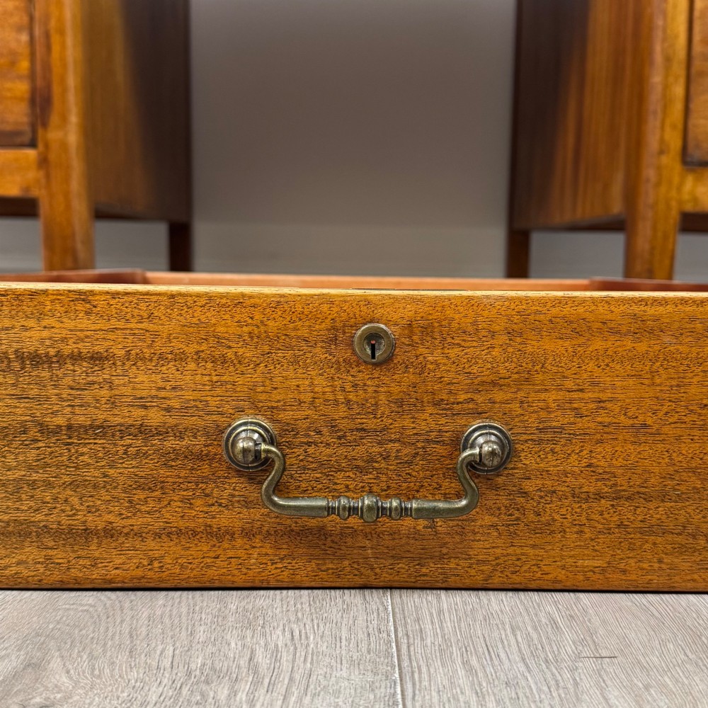 A large mid-20th century mahogany pedestal desk featuring two sets of drawers with brass drop handles and a central kneehole. View XI