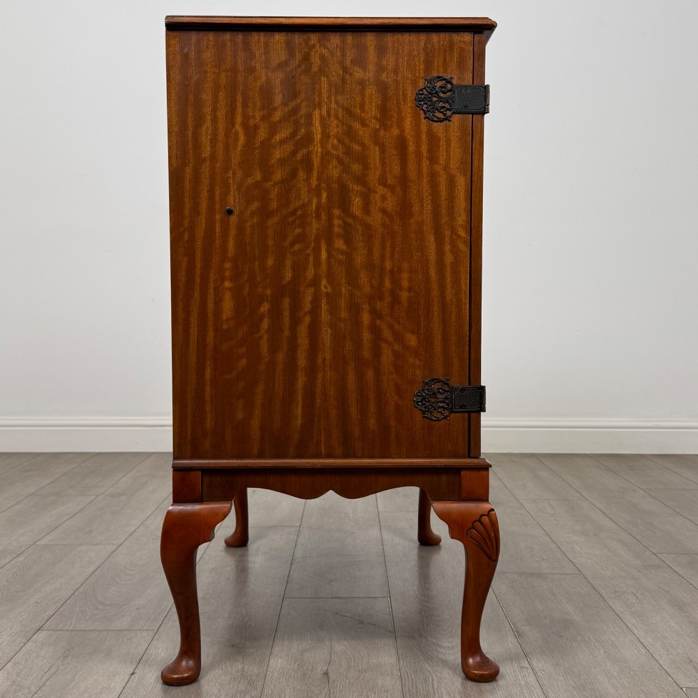 A 20th-century burr walnut two-door fitted cabinet on cabriole legs with carved shell knees and decorative pierced brass hinges. View VIII