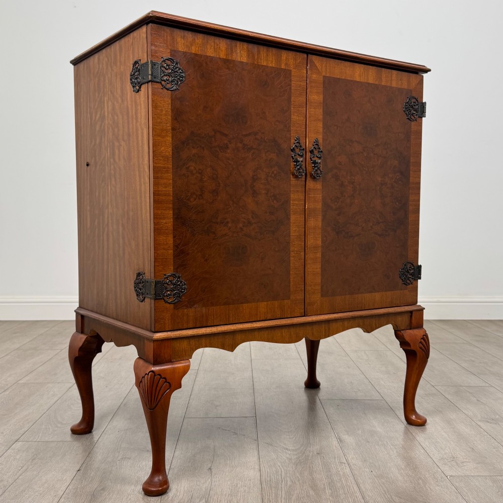 A 20th-century burr walnut two-door fitted cabinet on cabriole legs with carved shell knees and decorative pierced brass hinges. View IX