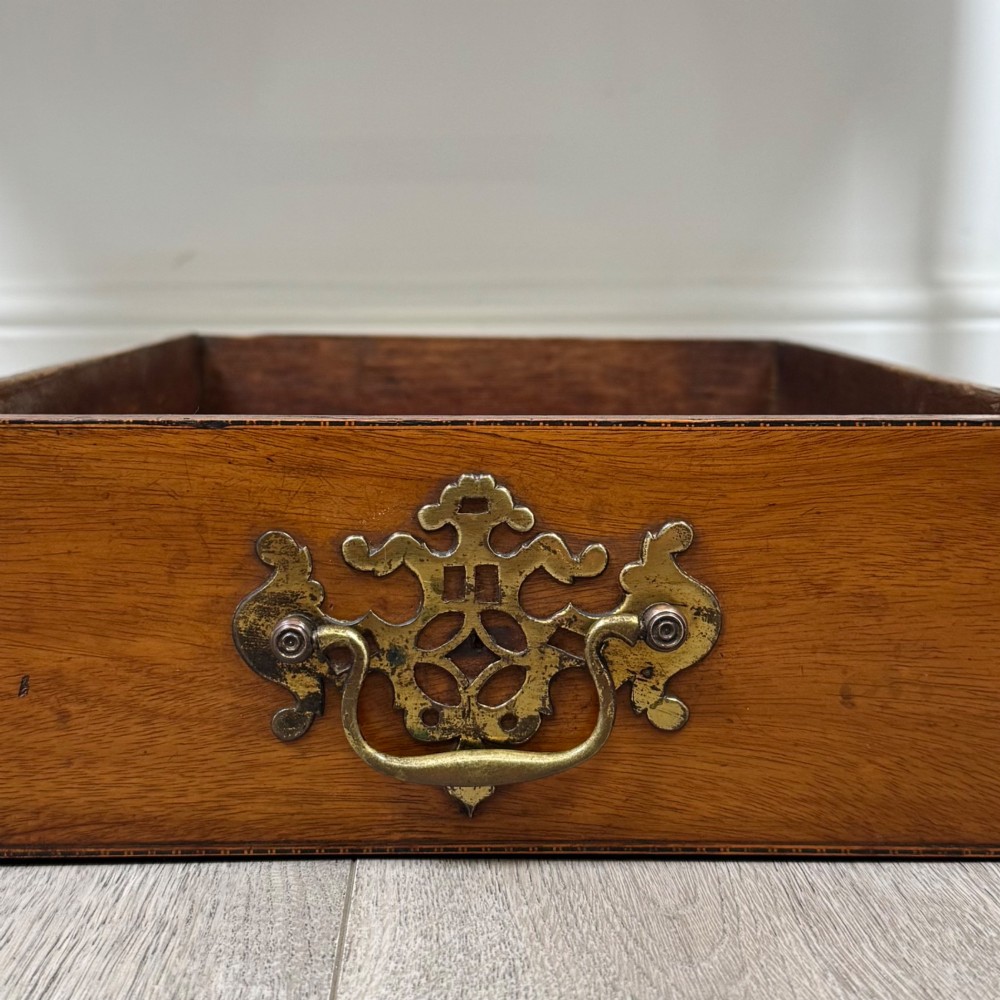 An 18th-century Georgian mahogany writing table with a bow-front top, three drawers fitted with brass handles, supported by square tapered legs. View XI