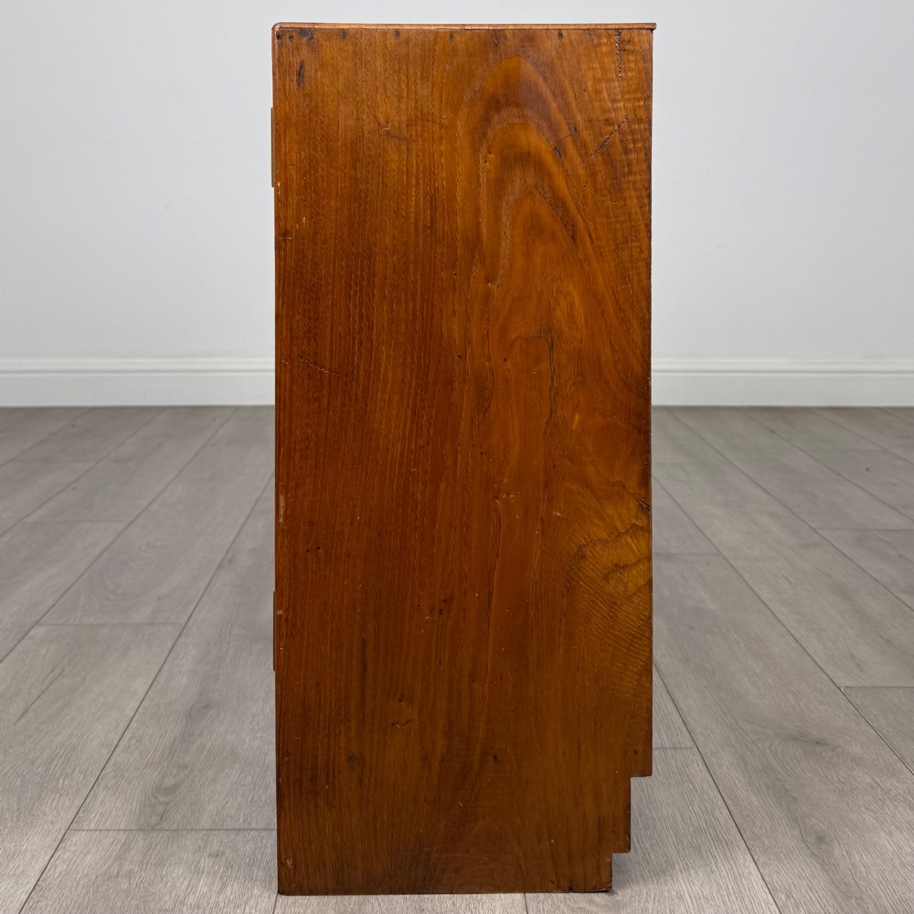 A compact golden oak sideboard featuring four shallow drawers on the left, an open shelf below, and a slatted single door cabinet on the right. View IV