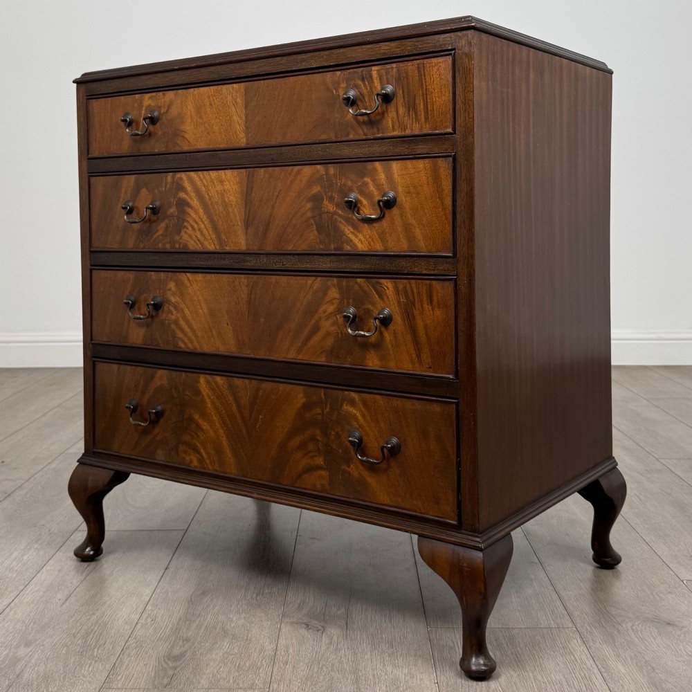 A mahogany chest of drawers featuring four full-width drawers with flame veneer fronts, brass handles, and cabriole legs. View II