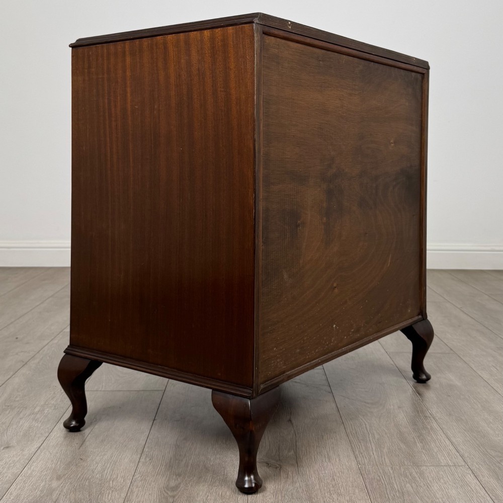 A mahogany chest of drawers featuring four full-width drawers with flame veneer fronts, brass handles, and cabriole legs. View IV