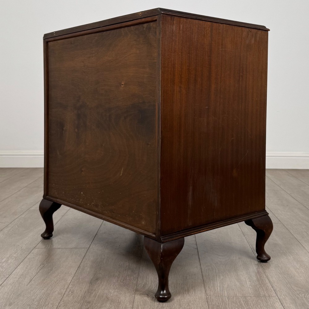 A mahogany chest of drawers featuring four full-width drawers with flame veneer fronts, brass handles, and cabriole legs. View VI