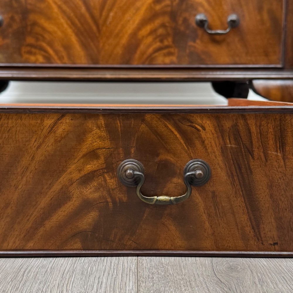 A mahogany chest of drawers featuring four full-width drawers with flame veneer fronts, brass handles, and cabriole legs. View XI
