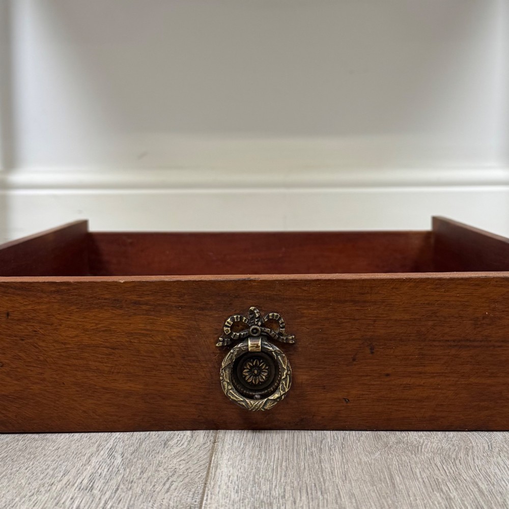 An early 20th-century mahogany writing table featuring three drawers with decorative brass ring handles and square tapered legs. View XI