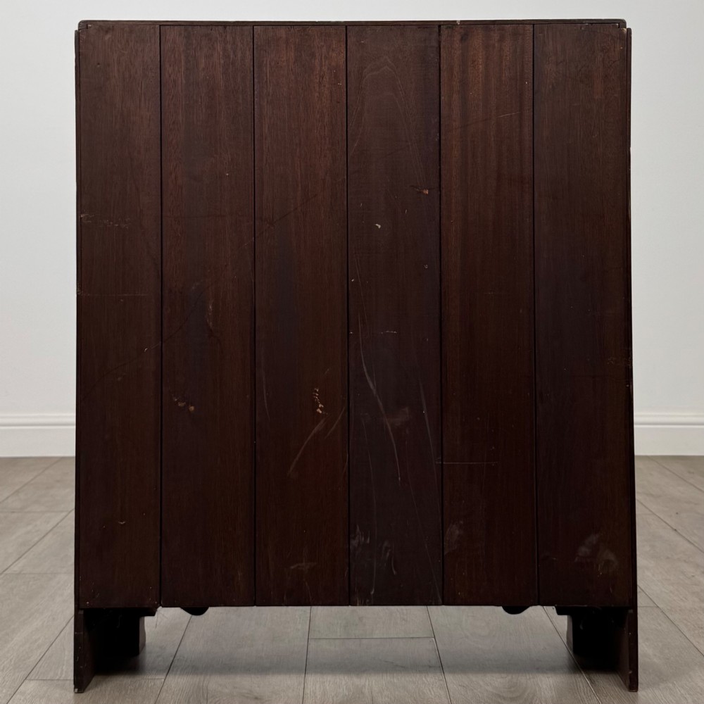 An antique narrow mahogany open bookcase featuring three tiers, a gadrooned top edge, and carved bracket feet. View VI