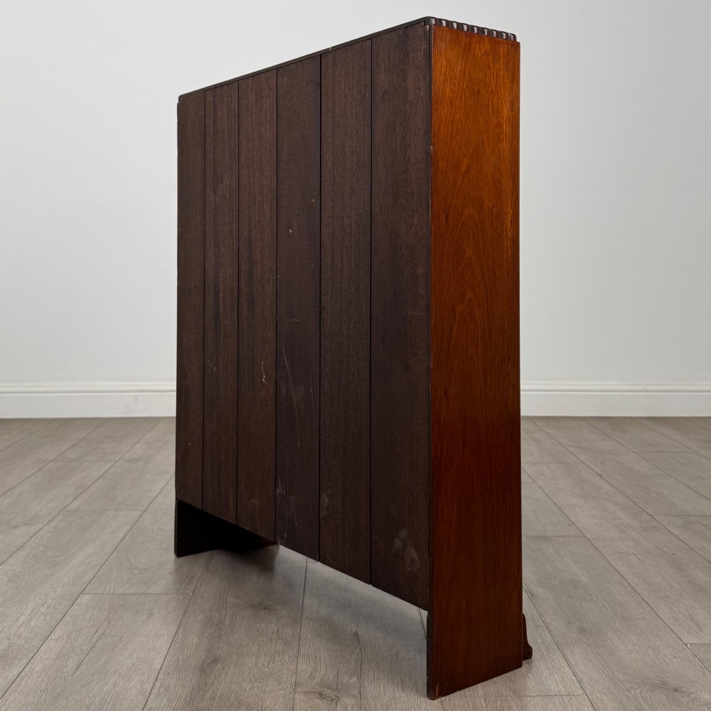An antique narrow mahogany open bookcase featuring three tiers, a gadrooned top edge, and carved bracket feet. View VII