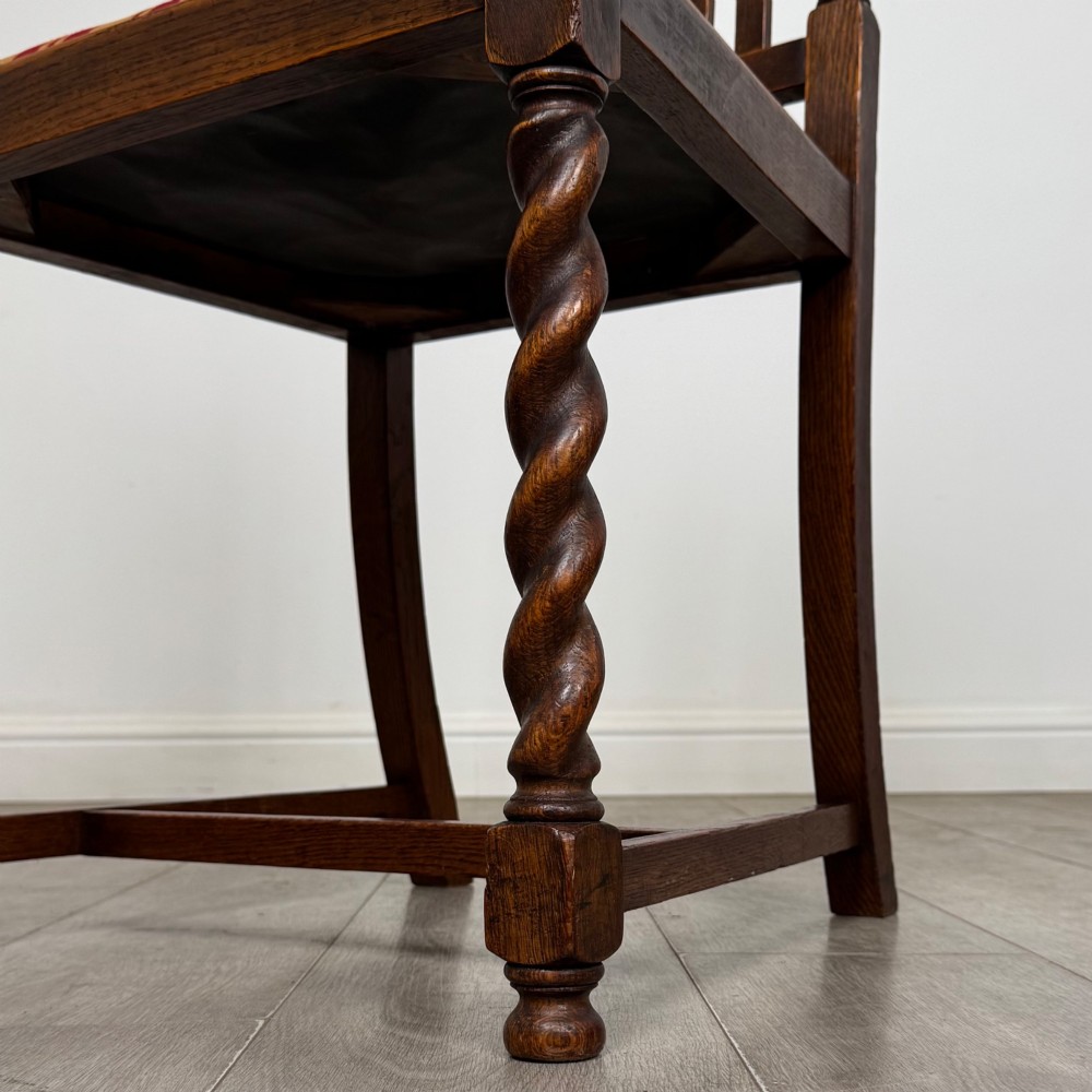 A set of six dark oak dining chairs featuring barley twist legs and stretchers with red and gold striped fabric seats. View VII