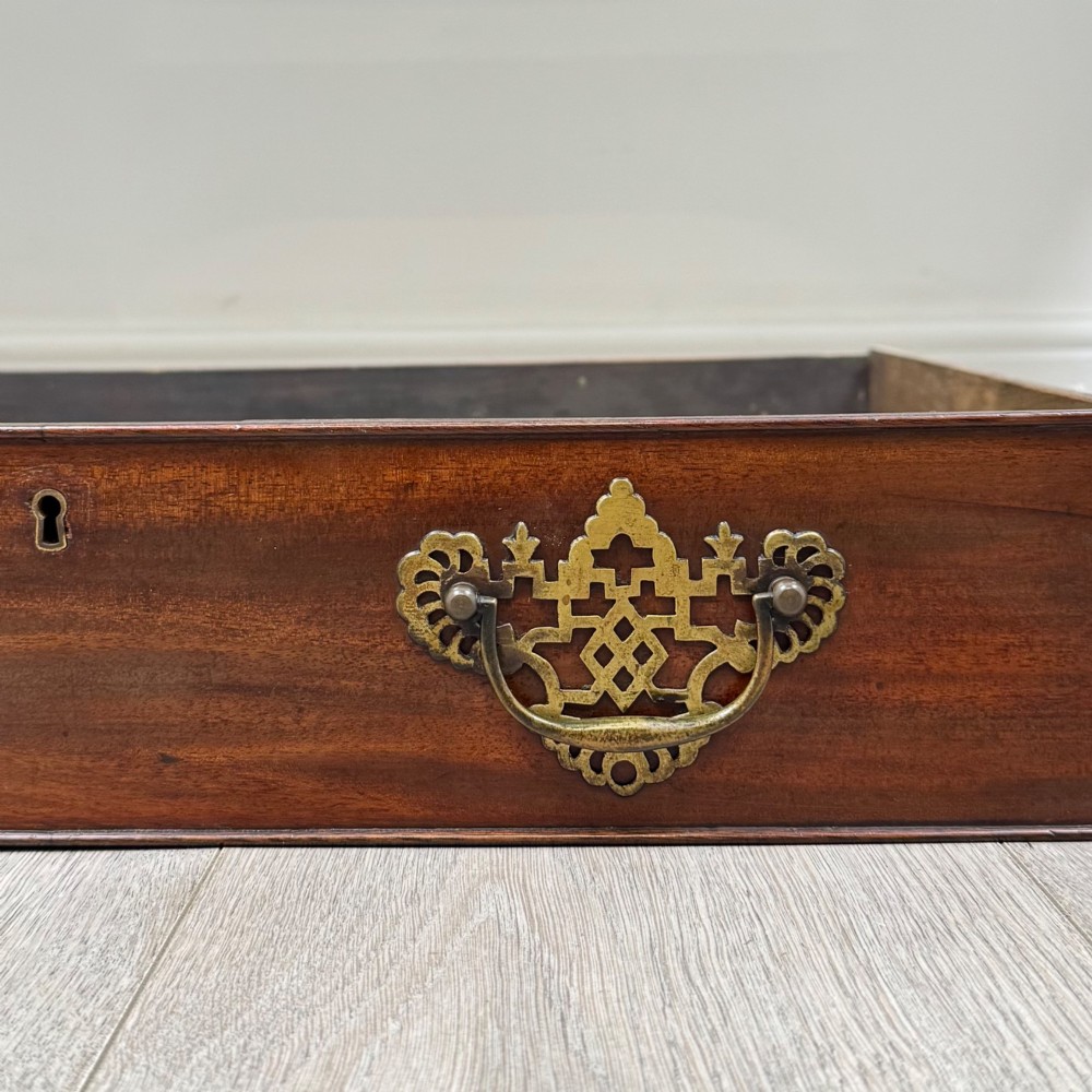 An Edwardian mahogany writing table with cabriole legs, carved knee detailing, three drawers with ornate brass handles, and a central arched kneehole. View XI