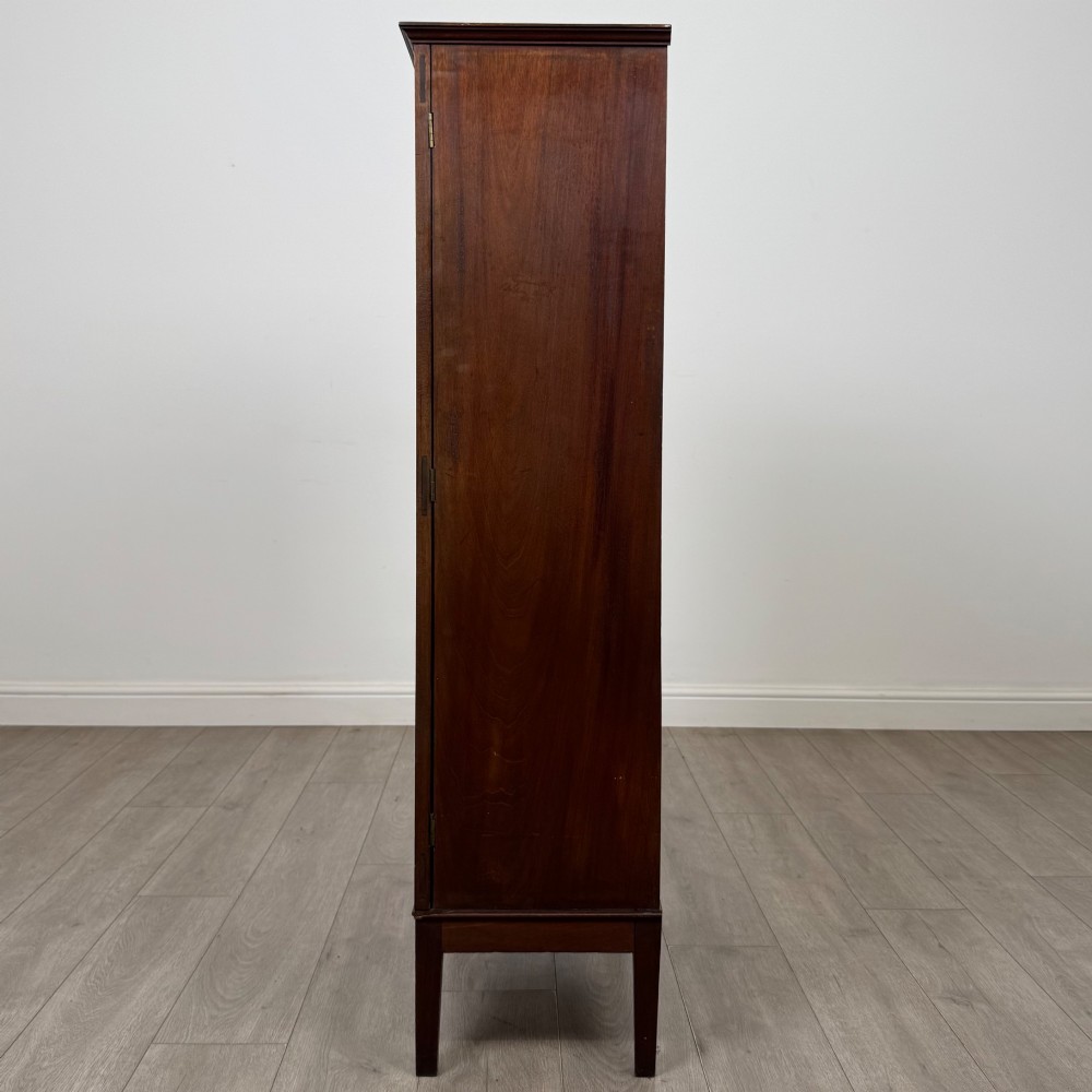 An 18th-century Georgian dark mahogany standing cabinet featuring two tall recessed field-panel doors, a subtle curved apron, and square tapered legs. View IV