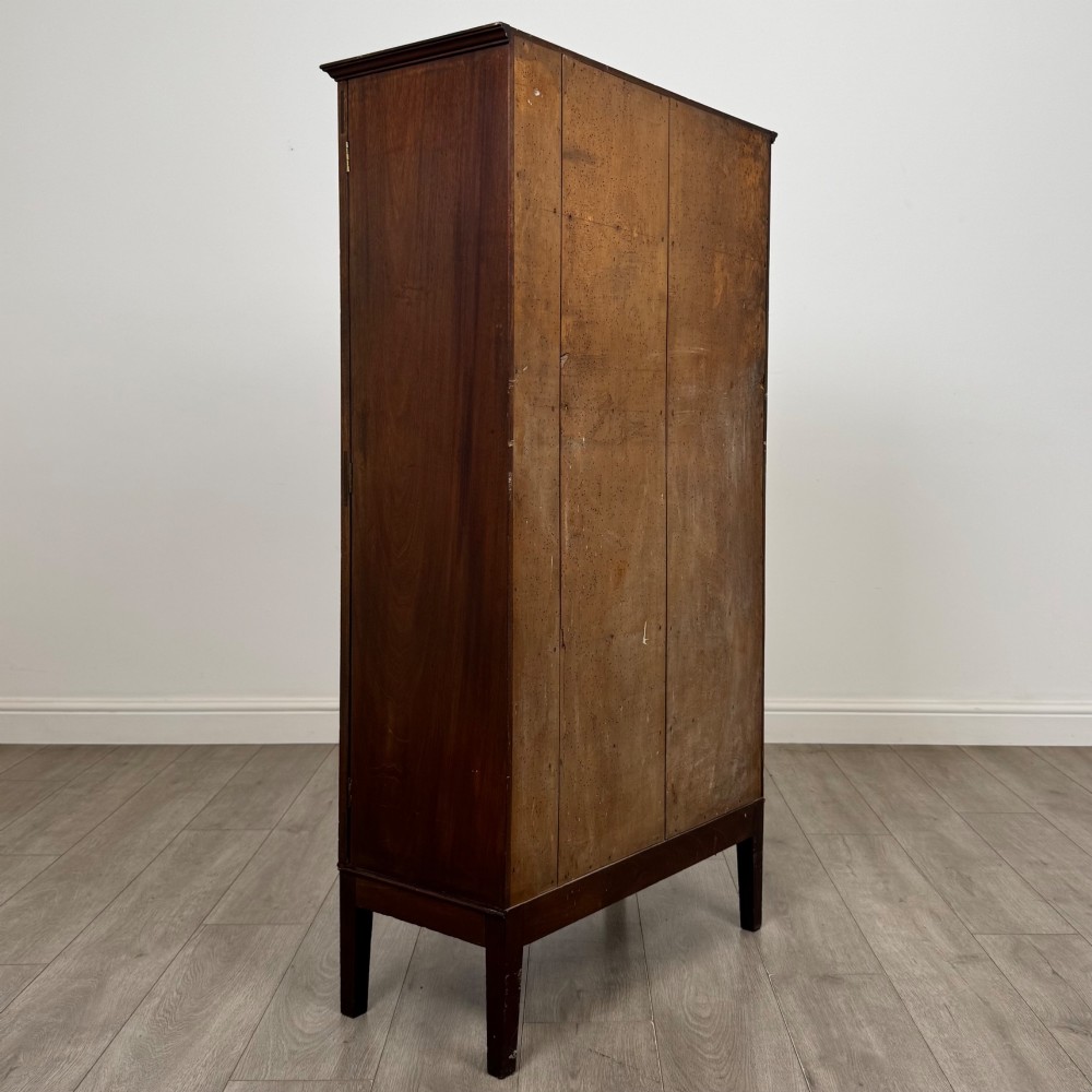 An 18th-century Georgian dark mahogany standing cabinet featuring two tall recessed field-panel doors, a subtle curved apron, and square tapered legs. View V