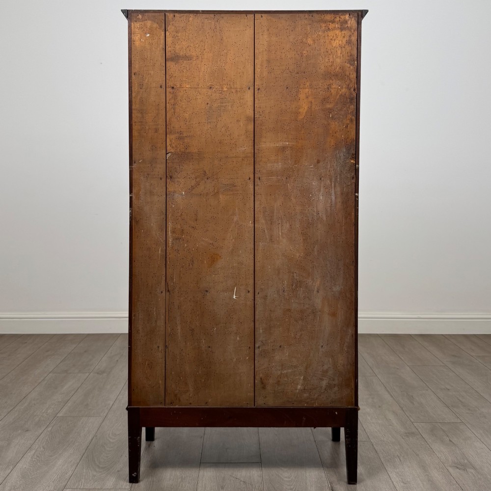 An 18th-century Georgian dark mahogany standing cabinet featuring two tall recessed field-panel doors, a subtle curved apron, and square tapered legs. View VI