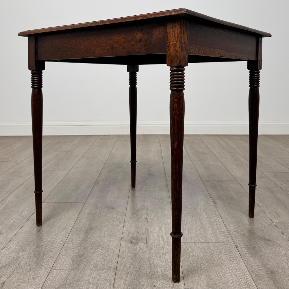 An antique Edwardian dark oak side table featuring slender turned legs with ring details and a smooth square top surface. View II