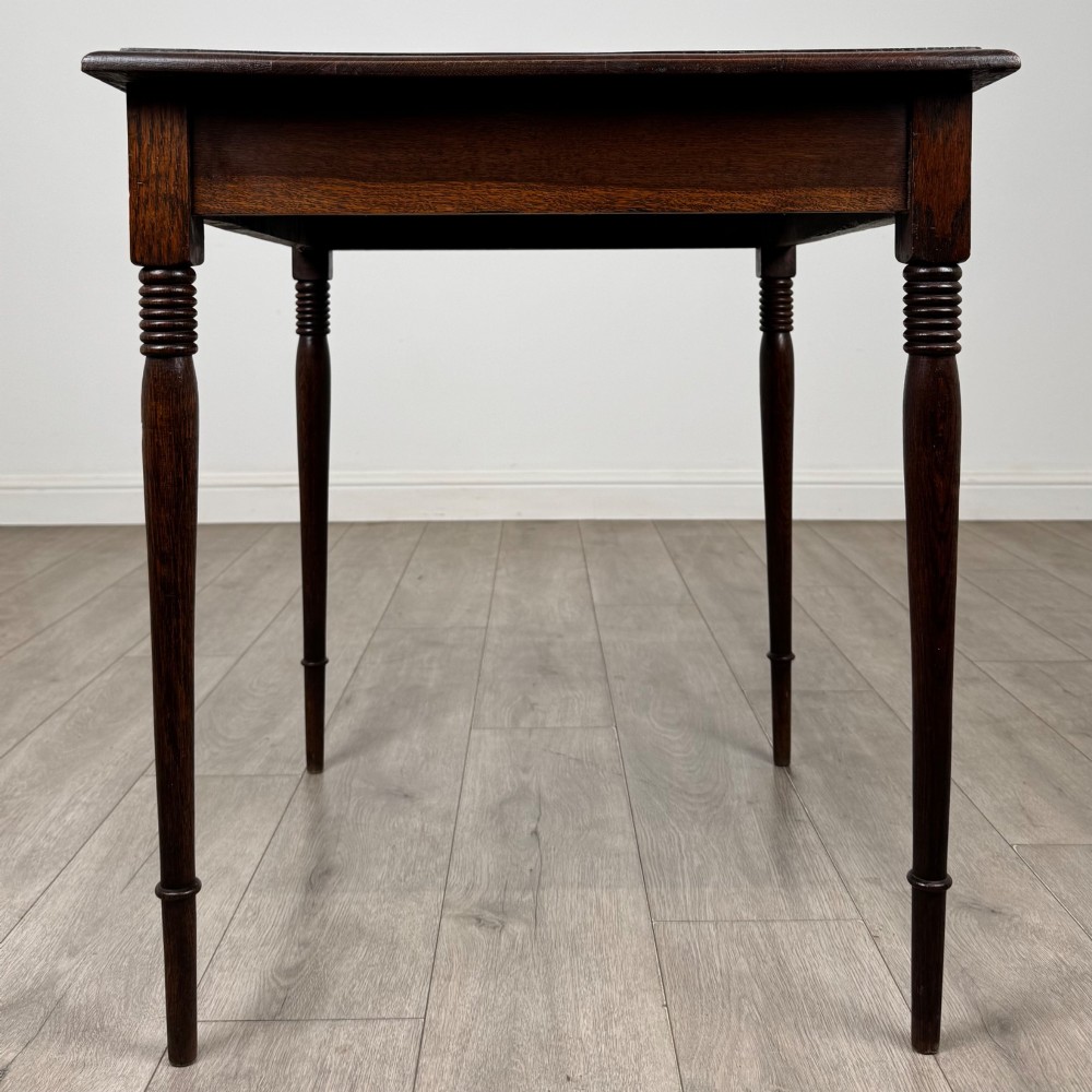 An antique Edwardian dark oak side table featuring slender turned legs with ring details and a smooth square top surface. View III
