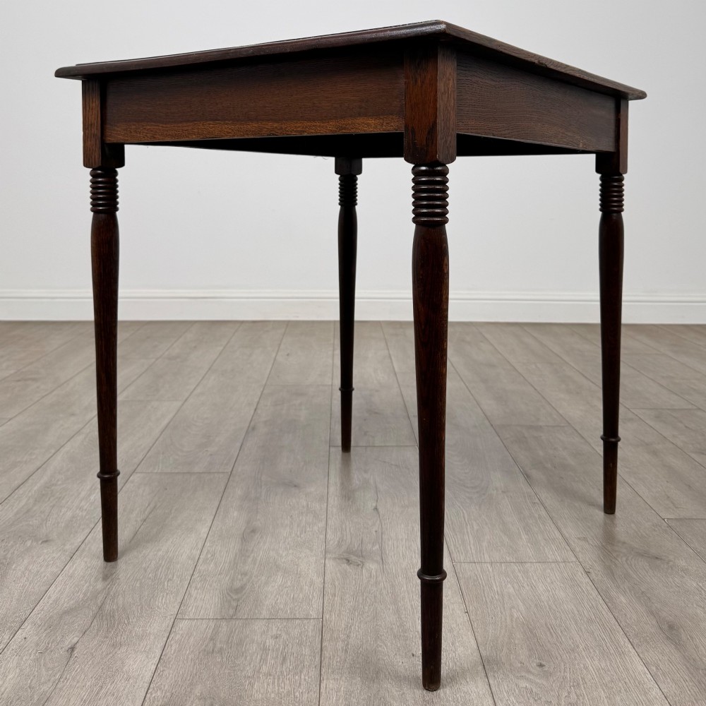 An antique Edwardian dark oak side table featuring slender turned legs with ring details and a smooth square top surface. View IV