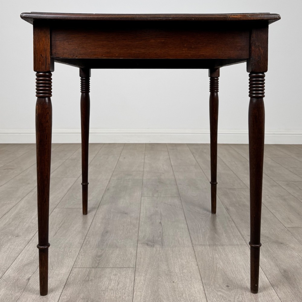 An antique Edwardian dark oak side table featuring slender turned legs with ring details and a smooth square top surface. View VII