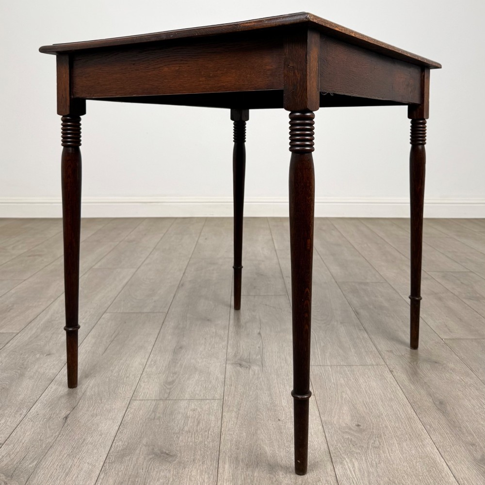 An antique Edwardian dark oak side table featuring slender turned legs with ring details and a smooth square top surface. View VIII