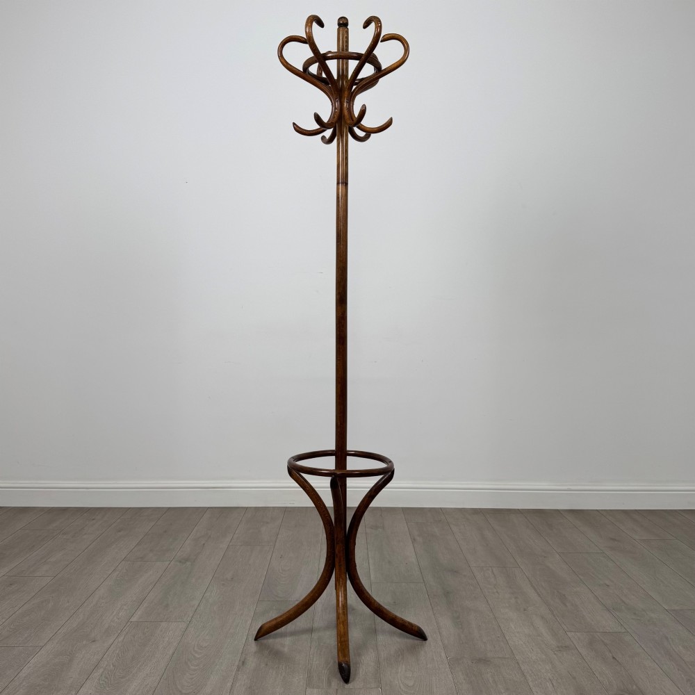 A freestanding bentwood beech coat stand featuring curved upper hooks, a central umbrella ring, and splayed feet. View II