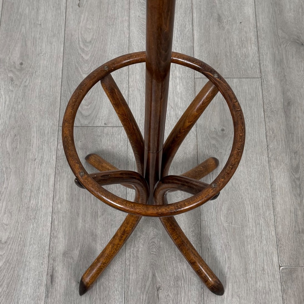 A freestanding bentwood beech coat stand featuring curved upper hooks, a central umbrella ring, and splayed feet. View III