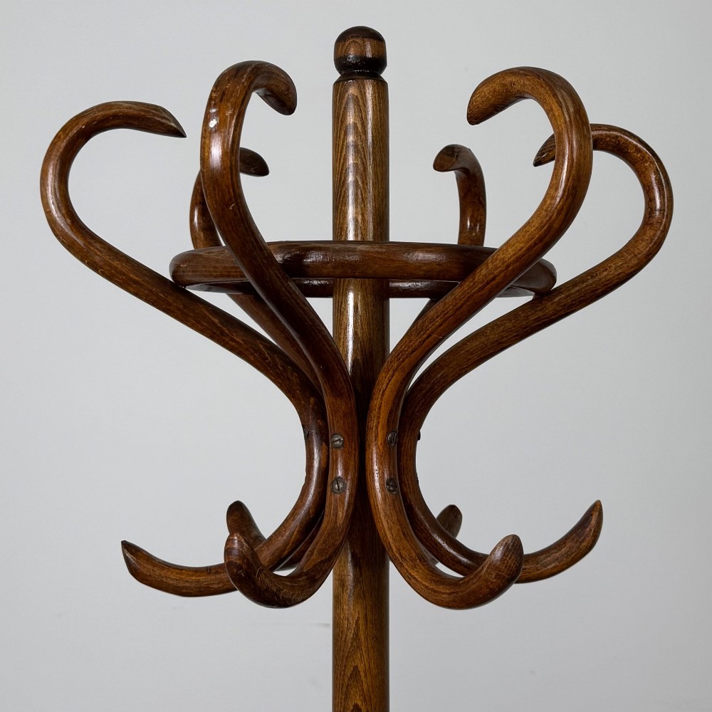 A freestanding bentwood beech coat stand featuring curved upper hooks, a central umbrella ring, and splayed feet. View IV