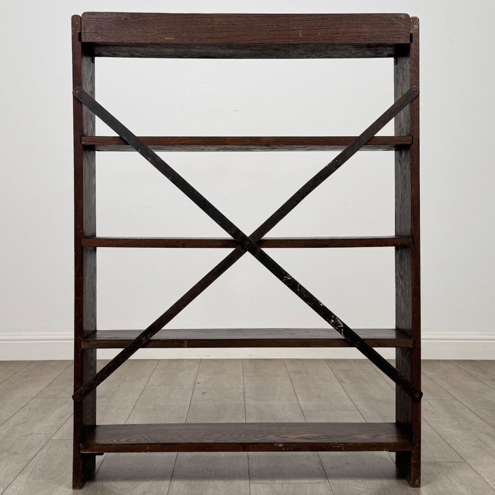 A dark oak open bookcase featuring five shelves and a black metal rear X-brace. View VI