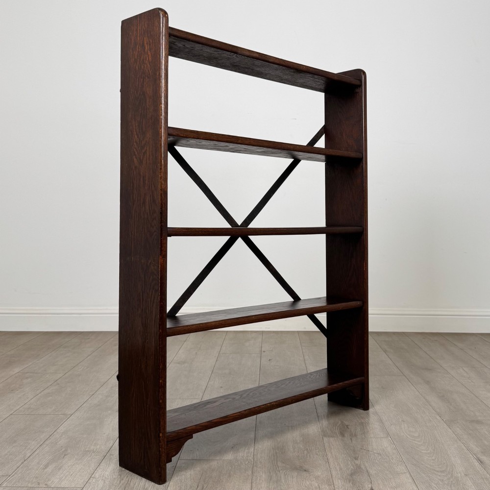 A dark oak open bookcase featuring five shelves and a black metal rear X-brace. View IX