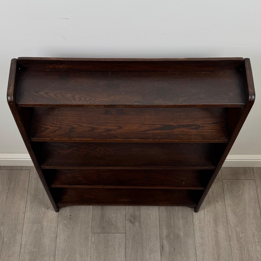 A dark oak open bookcase featuring five shelves and a black metal rear X-brace. View X