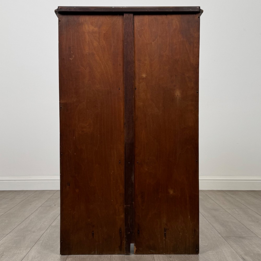 An antique walnut display cabinet featuring glazed door and side panels, decorative inlay along the frieze, and an open lower shelf resting on turned front legs. View VI