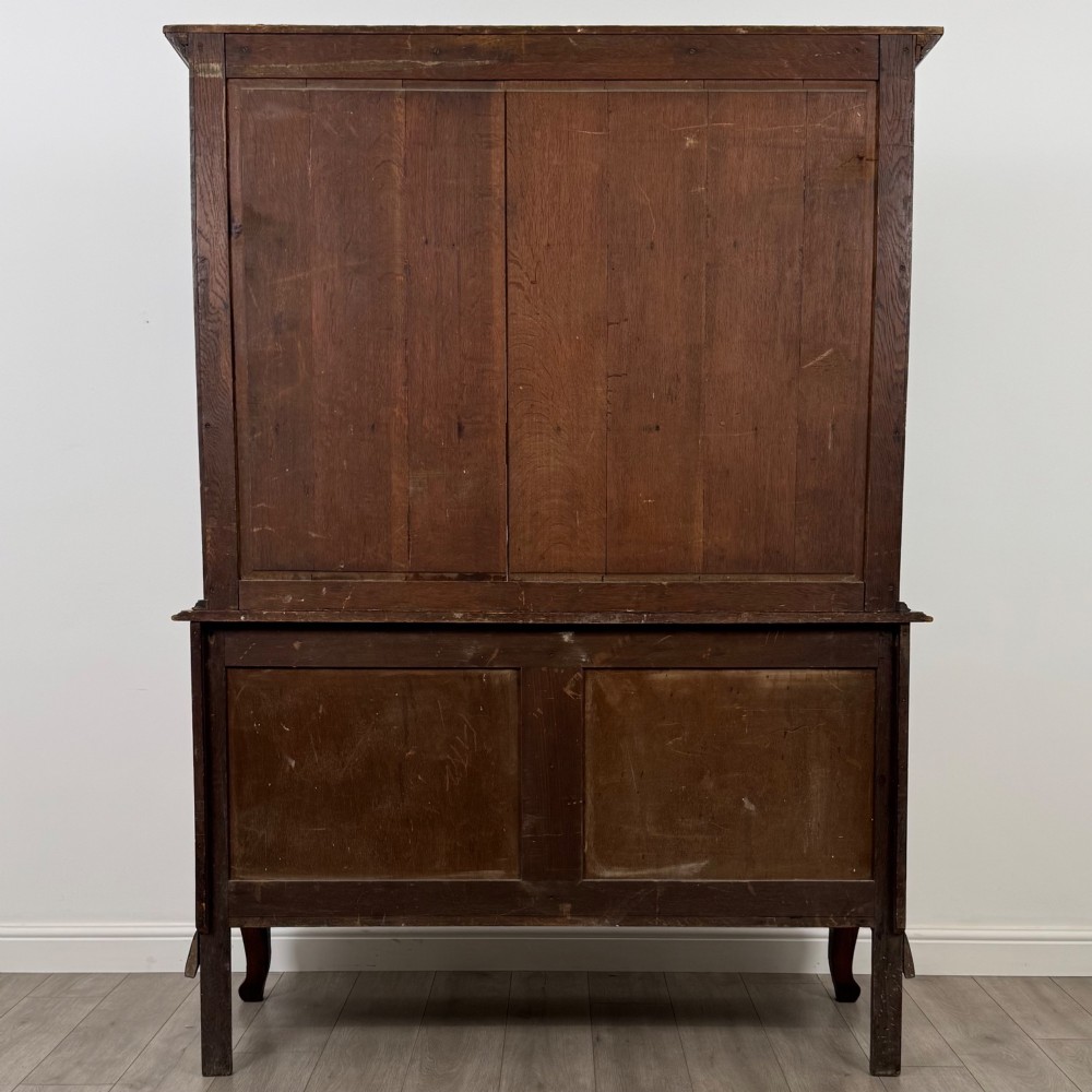 A 20th-century golden oak Welsh dresser featuring a three-tiered open shelf top section over a two-door, two-drawer base with cabriole legs. View VI