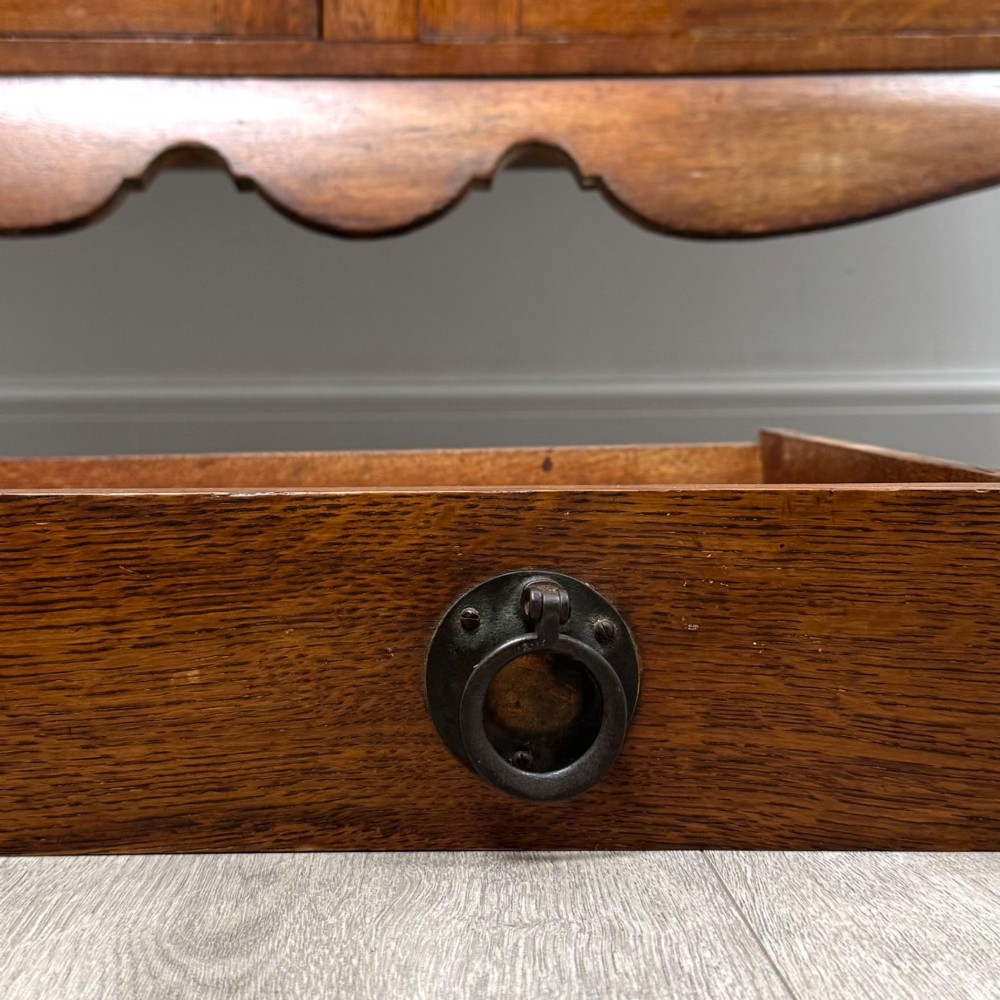A 20th-century golden oak Welsh dresser featuring a three-tiered open shelf top section over a two-door, two-drawer base with cabriole legs. View XII