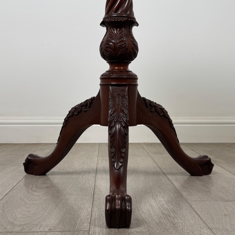 A dark mahogany tripod occasional table featuring a piecrust scalloped top, a birdcage mechanism, a spiral turned column, and leaf-carved legs. View V