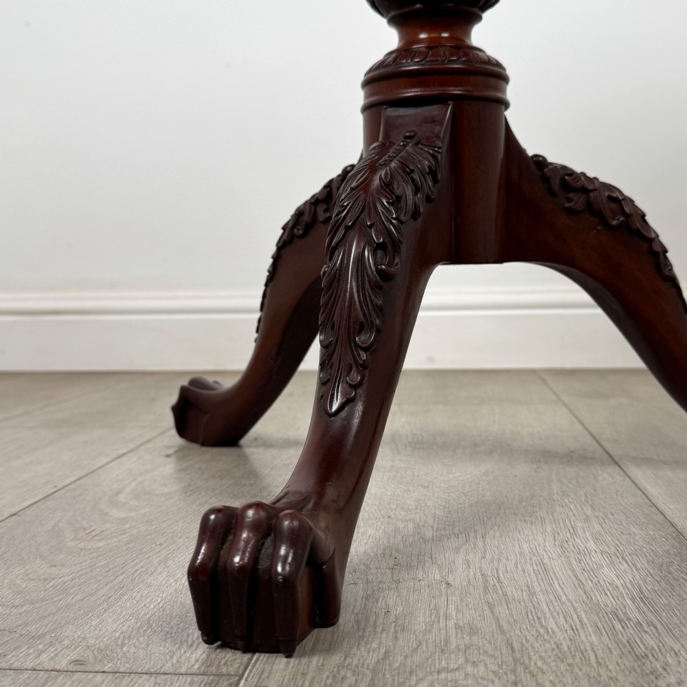 A dark mahogany tripod occasional table featuring a piecrust scalloped top, a birdcage mechanism, a spiral turned column, and leaf-carved legs. View VI