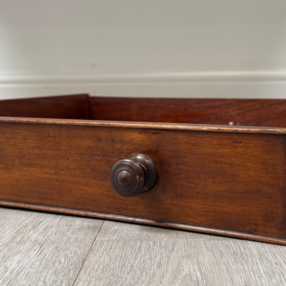 A 19th-century mahogany writing table featuring two frieze drawers with wooden turned handles, standing on four turned legs. View XI