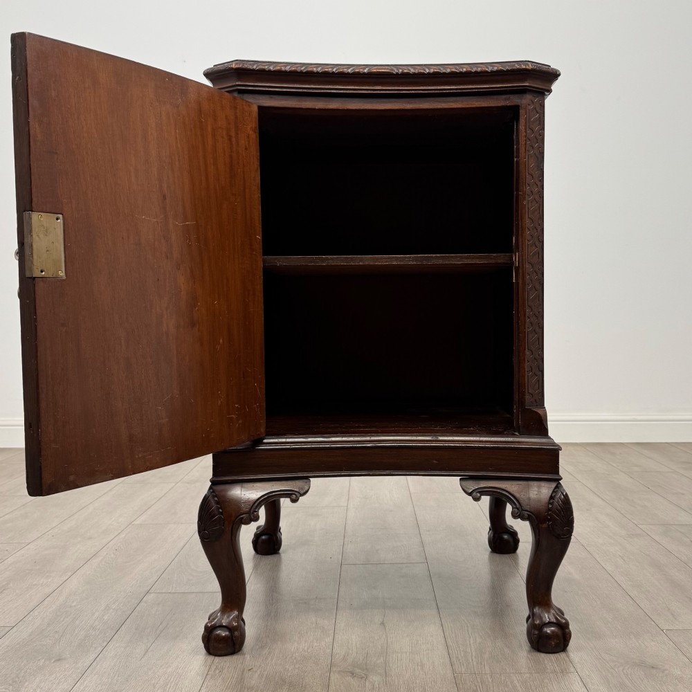 A dark mahogany Chippendale style cupboard featuring a single door with an oval flame mahogany panel, carved borders, and cabriole legs with ball-and-claw feet. View II