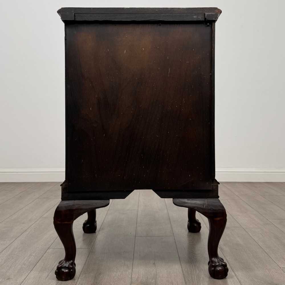 A dark mahogany Chippendale style cupboard featuring a single door with an oval flame mahogany panel, carved borders, and cabriole legs with ball-and-claw feet. View VI